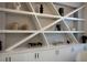 Built-in shelving with decor and wine storage at 10261 Largo Sassetta Ct, Las Vegas, NV 89135