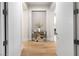 Elegant foyer featuring hardwood floors and a modern accent table with decorative vase at 10261 Largo Sassetta Ct, Las Vegas, NV 89135