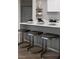 Modern kitchen with stainless steel appliances and island with seating at 10261 Largo Sassetta Ct, Las Vegas, NV 89135