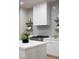 Kitchen with modern vent hood, stainless steel range, and open shelving at 10261 Largo Sassetta Ct, Las Vegas, NV 89135
