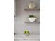 Kitchen shelf detail with decor and bowl of green apples at 10261 Largo Sassetta Ct, Las Vegas, NV 89135