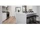 Kitchen with white marble countertop, bar stool seating and stainless steel appliances at 10261 Largo Sassetta Ct, Las Vegas, NV 89135