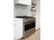 Stainless steel range with white cabinets and subway tile backsplash at 10261 Largo Sassetta Ct, Las Vegas, NV 89135