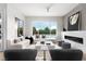 Bright living room with modern fireplace and large windows overlooking landscaped yard at 10261 Largo Sassetta Ct, Las Vegas, NV 89135