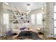 Stylish living room with modern furniture, white shelving, and neutral color palette offers a relaxing atmosphere at 10261 Largo Sassetta Ct, Las Vegas, NV 89135