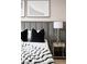 Comfortable main bedroom features a gray headboard, two black pillows, and stylish bedside tables at 10261 Largo Sassetta Ct, Las Vegas, NV 89135