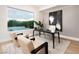 Stylish home office features a modern desk, comfortable seating, and a scenic pool view at 10261 Largo Sassetta Ct, Las Vegas, NV 89135