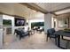 Inviting outdoor living area, featuring a built in grill, TV, dining table and comfortable seating arrangement at 10261 Largo Sassetta Ct, Las Vegas, NV 89135