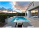 Inviting pool with lounge chairs offers a serene retreat against a backdrop of a stunning sunset at 10261 Largo Sassetta Ct, Las Vegas, NV 89135