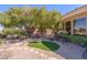 Backyard with mature trees, seating, and manicured landscaping, offering privacy and shade at 10524 Longwood Dr, Las Vegas, NV 89134