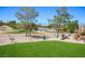 Beautiful backyard and green space with trees, manicured landscaping and distant mountain views at 10524 Longwood Dr, Las Vegas, NV 89134