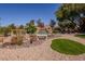 Backyard landscape design with water feature, greenery, and decorative rock at 10524 Longwood Dr, Las Vegas, NV 89134