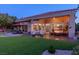 Expansive backyard with a patio area, manicured lawn, and desert landscaping, perfect for outdoor living at 10524 Longwood Dr, Las Vegas, NV 89134