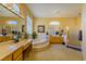 Large bathroom with dual vanities, soaking tub and tiled shower stall at 10524 Longwood Dr, Las Vegas, NV 89134