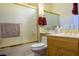 Well-maintained bathroom featuring a shower, toilet, sink and vanity with gold hardware at 10524 Longwood Dr, Las Vegas, NV 89134