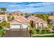 Stunning single-story home boasting a three-car garage, beautiful landscaping, and tile roof with solar panels at 10524 Longwood Dr, Las Vegas, NV 89134