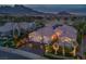Aerial view of a home featuring a three-car garage, desert landscaping, a red tile roof, and solar panels at 10524 Longwood Dr, Las Vegas, NV 89134
