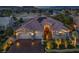 Stunning home featuring a three-car garage, stone accents, a red tile roof, solar panels, and manicured landscaping at 10524 Longwood Dr, Las Vegas, NV 89134
