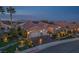 Aerial dusk view showing well-maintained landscaping, solar panels, and a three-car garage at 10524 Longwood Dr, Las Vegas, NV 89134