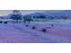 A serene golf course with rolling green hills and distant mountain views at dusk at 10524 Longwood Dr, Las Vegas, NV 89134