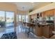 Spacious kitchen with marble countertops, stainless steel appliances, and breakfast bar seating at 10524 Longwood Dr, Las Vegas, NV 89134