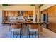 A gourmet kitchen featuring a granite island, stainless steel appliances and plenty of cabinets at 10524 Longwood Dr, Las Vegas, NV 89134