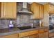 Close-up of kitchen with stainless appliances, tiled backsplash and wooden cabinets at 10524 Longwood Dr, Las Vegas, NV 89134