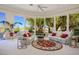Bright living room with large windows, comfortable seating, and a view of the landscaped backyard at 10524 Longwood Dr, Las Vegas, NV 89134