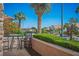 Inviting patio with outdoor seating and views of palm trees and city skyline in the background at 10524 Longwood Dr, Las Vegas, NV 89134