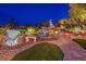 Picturesque backyard pond featuring a waterfall, rock features, and lush landscaping at 10524 Longwood Dr, Las Vegas, NV 89134