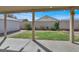 View of the spacious backyard from a covered patio, showcasing the grassy area, privacy wall and storage shed at 1109 Pincay Dr, Henderson, NV 89015