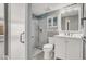 The staged bathroom features a shower, tile accents, white vanity and decor at 1109 Pincay Dr, Henderson, NV 89015