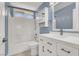 This stylish bathroom has a shower over tub, a window, and modern vanity with drawers at 1109 Pincay Dr, Henderson, NV 89015