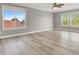 Bright bedroom with views from multiple windows, neutral gray paint, and ample space at 1109 Pincay Dr, Henderson, NV 89015