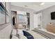 This staged bedroom includes a mirrored closet, ceiling fan, and TV at 1109 Pincay Dr, Henderson, NV 89015