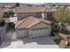 Two-story home featuring a three-car garage, tile roof, and desert landscaping at 1109 Pincay Dr, Henderson, NV 89015