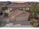 Two-story home featuring a three car garage, well-maintained landscaping, and a beautiful desert sunset backdrop at 1109 Pincay Dr, Henderson, NV 89015