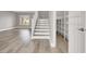 Hallway leading to the stairs featuring new floors, with access to shelving storage at 1109 Pincay Dr, Henderson, NV 89015