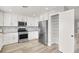 This staged kitchen has white cabinets, stainless appliances, a large refrigerator and a pantry at 1109 Pincay Dr, Henderson, NV 89015