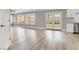 Bright, open-concept living area featuring light wood floors, neutral walls, and double doors to the backyard at 1109 Pincay Dr, Henderson, NV 89015