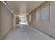 Long, covered side yard, featuring a concrete walkway with a block wall and some natural light at 1109 Pincay Dr, Henderson, NV 89015