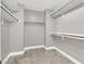 The walk-in closet features wood look floors and multiple shelves and rods for clothing storage at 1109 Pincay Dr, Henderson, NV 89015