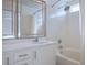 Bright bathroom featuring double sinks, stylish mirrors, and a shower-tub combo with updated fixtures at 11091 Parete Ct, Las Vegas, NV 89141