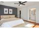 Comfortable bedroom features neutral decor, ceiling fan, walk-in closet and ensuite bathroom access at 11091 Parete Ct, Las Vegas, NV 89141