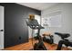 Exercise room features a spin bike, storage rack, and hardwood floors at 11091 Parete Ct, Las Vegas, NV 89141