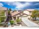 Charming single-story home with a well-maintained lawn and a two-car garage, perfect for a Gathering at 11091 Parete Ct, Las Vegas, NV 89141