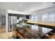 Well-lit kitchen with large island, stainless steel appliances, and black cabinets at 11091 Parete Ct, Las Vegas, NV 89141