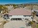 An aerial view captures the home's backyard with desert landscaping, a covered patio, and mountain views at 1131 China St, Pahrump, NV 89048