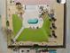 Stunning aerial view of a backyard oasis with a kidney-shaped pool, lush lawn, and desert landscaping at 1131 China St, Pahrump, NV 89048