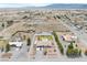 An aerial view shows a house with a pool, ample parking, desert landscaping, and mountain backdrop at 1131 China St, Pahrump, NV 89048